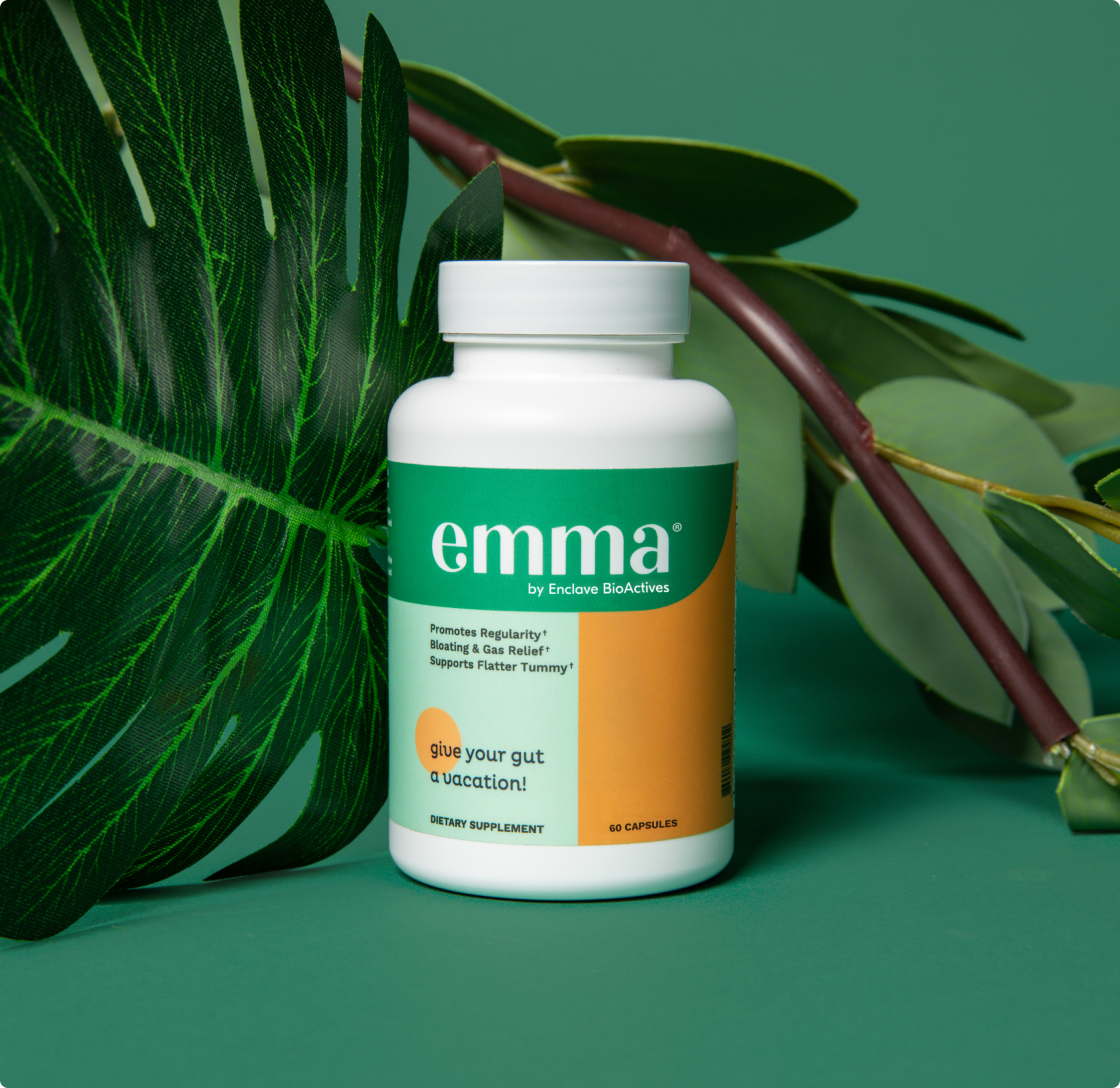 a bottle of medicine next to a leaf